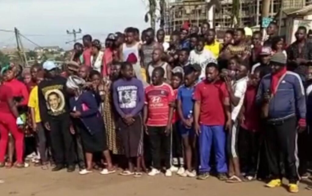 Locals watch the displayed corpses in shock